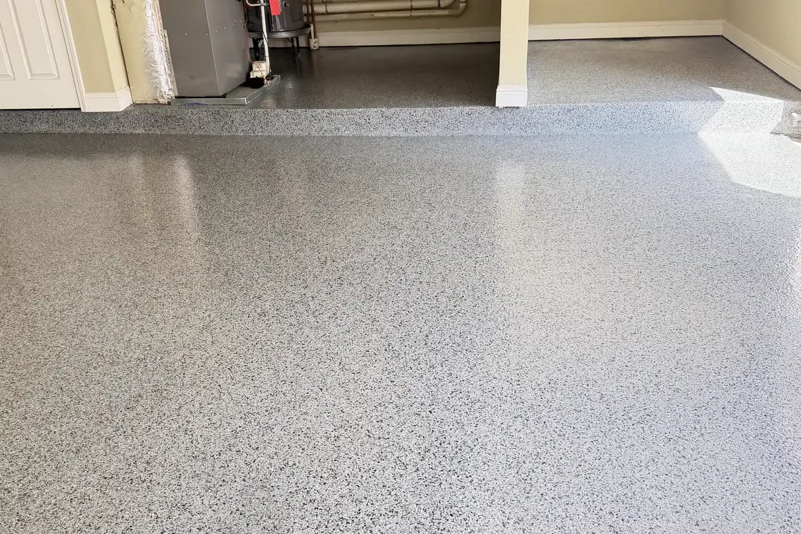 The finished grey flake epoxy garage floor