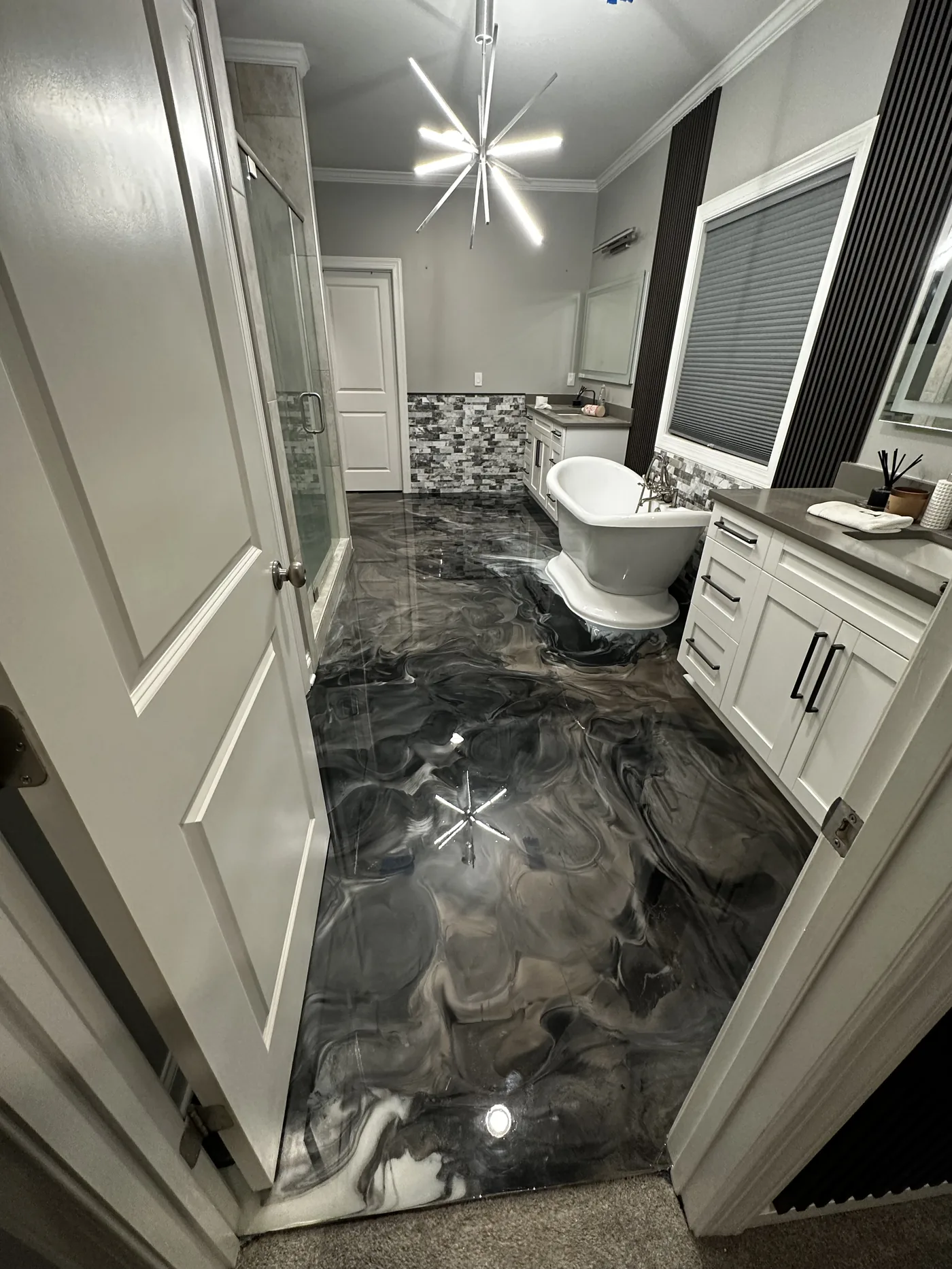Black and silver metallic epoxy bathroom floor